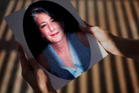 Judy Robins holds a portrait of her sister Dorothy 'Jeanie' Rising, who died in July 2006 of cancer. One of Rising's caregivers, Carolyn Claeys, was found passed out, high on drugs, in Rising's apartment a day after she died. Claeys admitted to authorities that she had stolen Rising's painkillers and injected them. (Liz O. Baylen/Los Angeles Times)